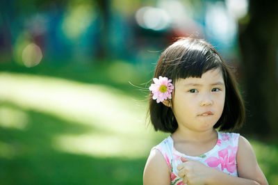 Close-up portrait of girl standing at park