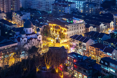 High angle view of city lit up at night