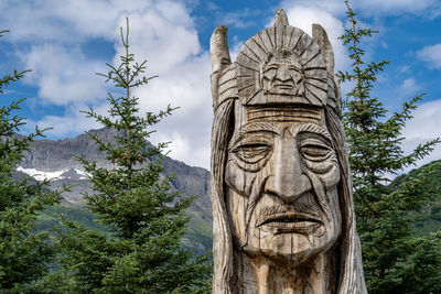 Low angle view of statue against trees