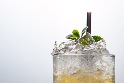 Close-up of beer glass on table against white background