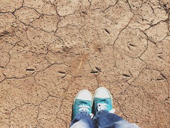 Low section of person standing on tiled floor