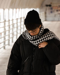 Rear view of woman standing against wall