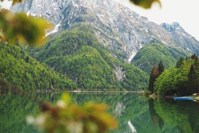 Scenic view of lake by mountains against sky