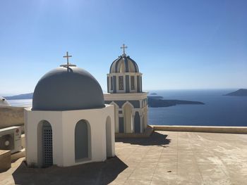 Blue domes by sea against clear sky