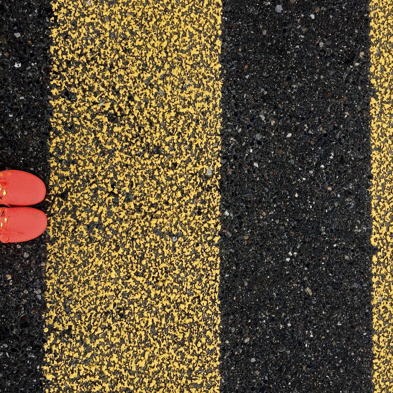 street, high angle view, asphalt, road, yellow, textured, transportation, road marking, one person, sidewalk, season, outdoors, day, full frame, red, pattern, low section, autumn, cobblestone, standing