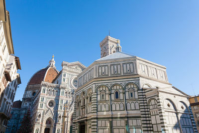 Low angle view of building against clear blue sky