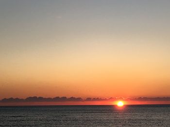 Scenic view of sea against clear sky during sunset