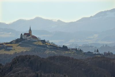 Panoramic view of building and mountains against sky