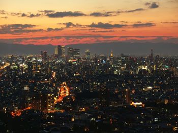 High angle view of illuminated buildings against sky at night