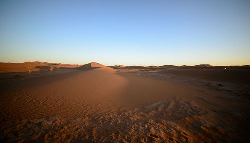 Scenic view of desert against clear blue sky