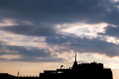 Buildings against cloudy sky