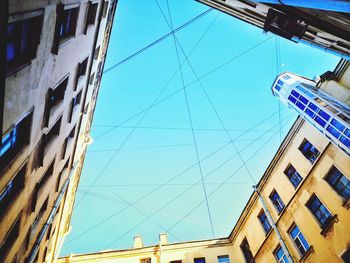 Low angle view of modern building against blue sky