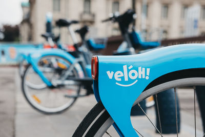 Close-up of bicycle sign on street in city