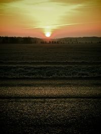 Scenic view of field against sky during sunset