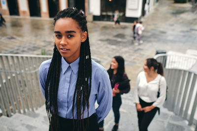 Portrait of woman standing in city