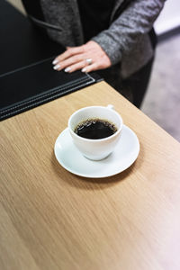 Cup of black coffee on desk