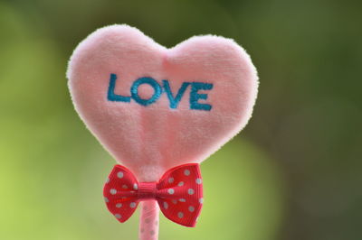 Close-up of heart shape against pink background