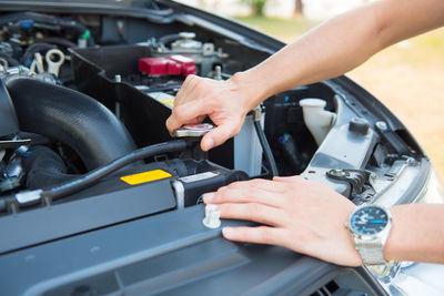 A man checking the auto engine,  uses a wrench to fix the car engine,repair service.