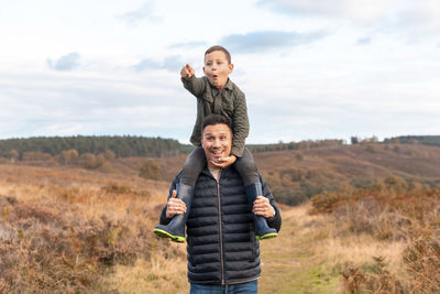 Portrait of smiling boy standing on field