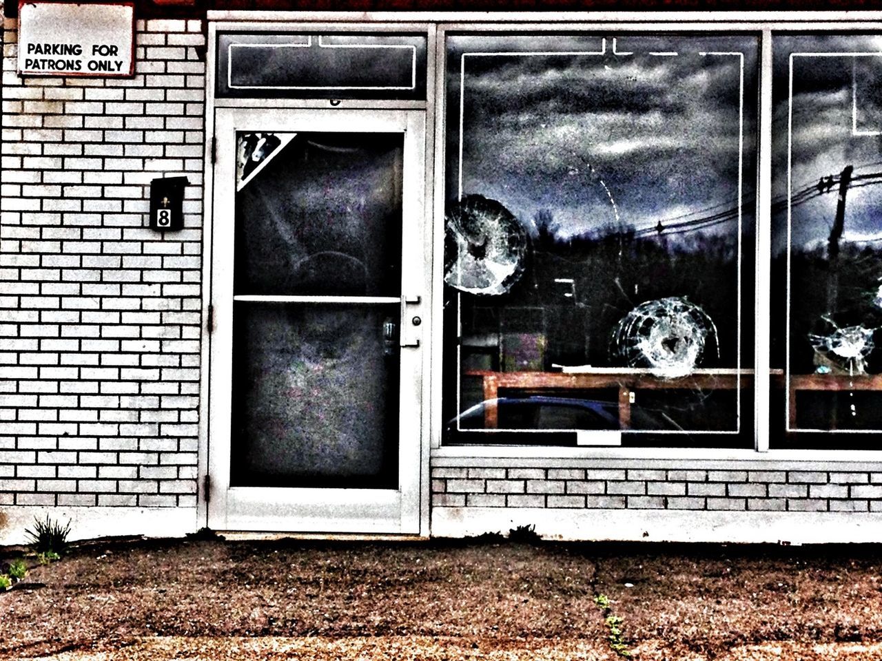 building exterior, window, architecture, built structure, glass - material, house, transparent, abandoned, sky, day, graffiti, closed, no people, transportation, damaged, outdoors, obsolete, door, land vehicle, building