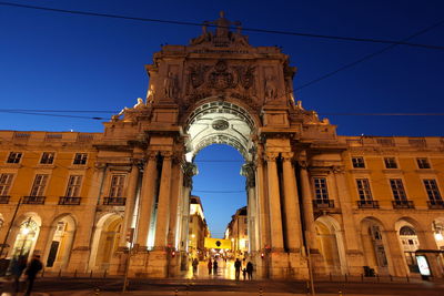 Low angle view of illuminated rua augusta arch in city