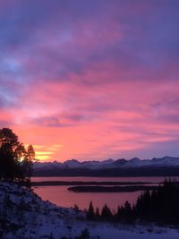 Scenic view of lake against romantic sky at sunset