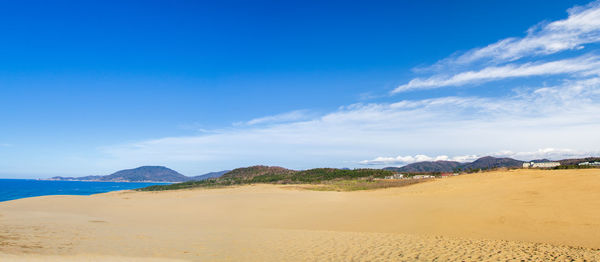 Scenic view of beach against blue sky