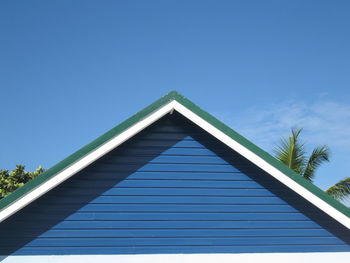 Low angle view of office building against blue sky