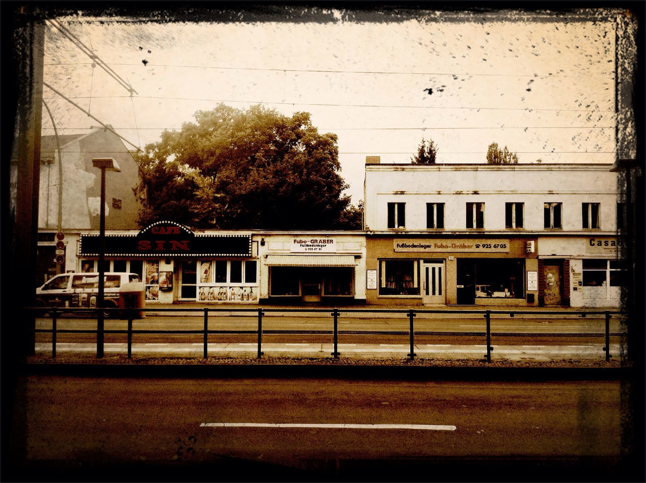 building exterior, architecture, built structure, transfer print, transportation, auto post production filter, city, window, mode of transport, street, building, land vehicle, incidental people, public transportation, city life, day, outdoors, railroad track, railroad station, car