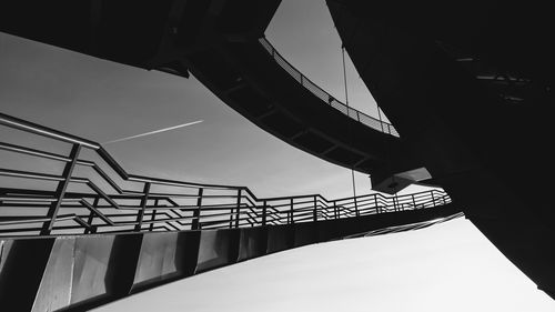 Low angle view of spiral staircase by building against sky