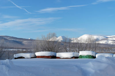 Snow covered landscape against sky