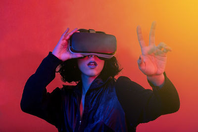 Woman is using virtual reality viewer. modern woman portrait with trendy look and bright colors.