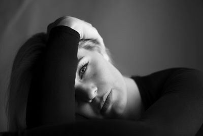 Portrait of man lying down on bed at home