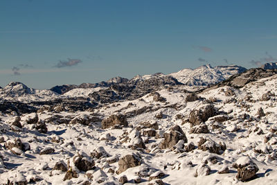 Scenic view of snowcapped mountains against clear blue sky