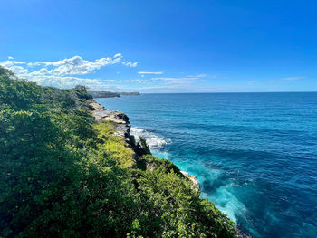 Scenic view of sea against blue sky