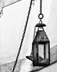 Low angle view of metal chain hanging outdoors