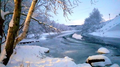 Scenic view of frozen lake against sky during winter