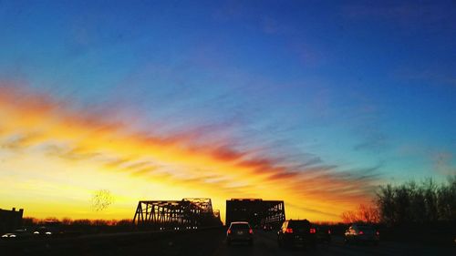 Traffic on road at sunset