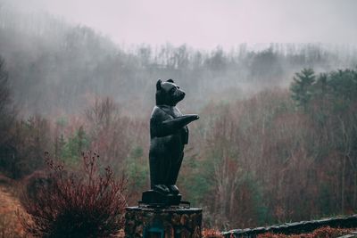 Statue against sky during winter