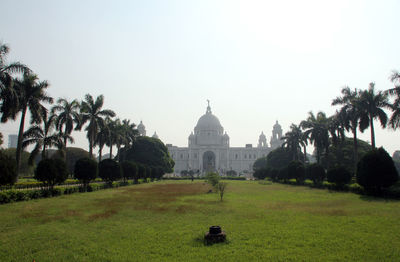 People in front of temple against clear sky