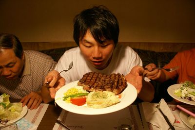 Woman eating food in restaurant