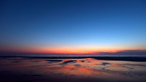 Scenic view of sea against clear sky during sunset