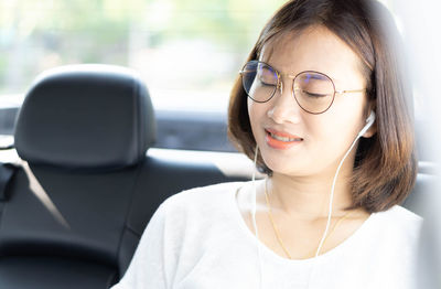 Portrait of young woman in car