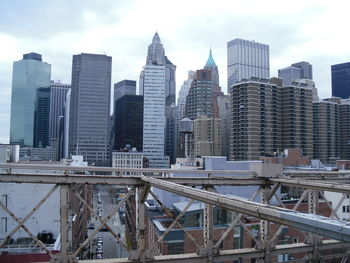 Brooklyn bridge against modern buildings at manhattan