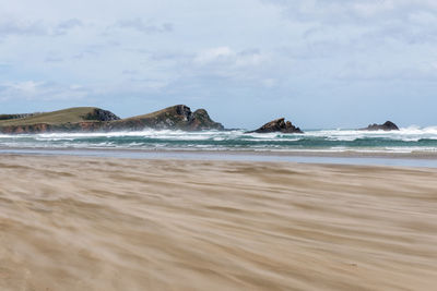 View of beach against cloudy sky