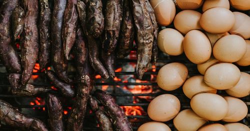 Directly above shot of meat and eggs on barbecue