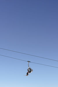 Low angle view of airplane flying against clear sky