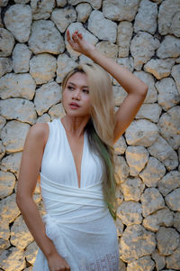 Beautiful blonde haired woman in white dress