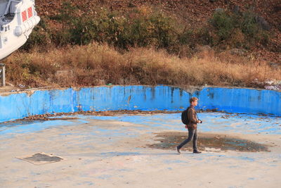 Side view of boy standing in water