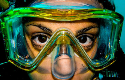 Close-up portrait of woman scuba diving in sea